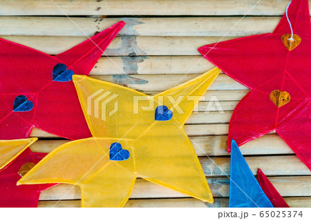 Close up to traditional star-shaped kite or thai name Chula kite for sale to fly at local market.  Selective focus. 65025374