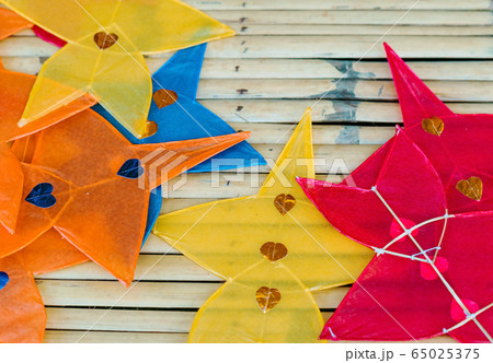 Close up to traditional star-shaped kite or thai name Chula kite for sale to fly at local market.  Selective focus. 65025375