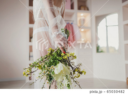Bride in wedding dress holding bouquet. Bride in wedding dress holding bouquet. 65030482