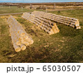 Rolls of haystacks on the field as agriculture harvest concept. 65030507
