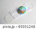 globe lies on a medical mask during a coronavirus 65031248