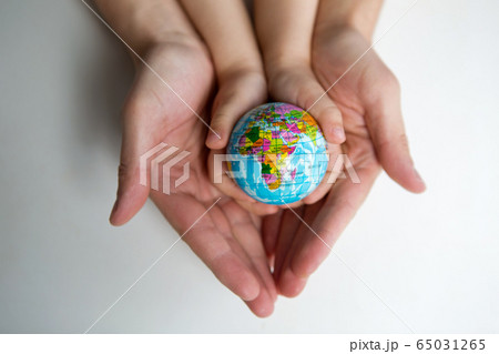 baby and hand of adult man holding a small globe during the epidemic baby and hand of adult man holding a small globe during the epidemic 65031265