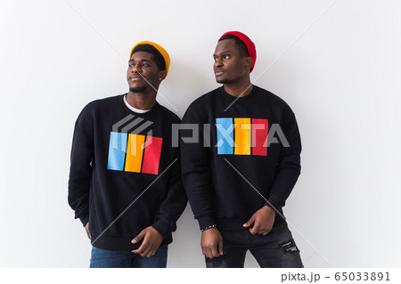 Street fashion and friendship concept - Two happy african american young men in black stylish sweatshirts. Street fashion and friendship concept - Two happy african american young men in black stylish sweatshirts. 65033891