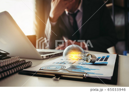 portrait of light bulb,stressed business man with social network diagram in the office. portrait of light bulb,stressed business man with social network diagram in the office. 65033946