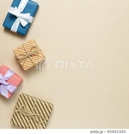 Gift boxes on beige background. flat lay, top view, copy space 65041303