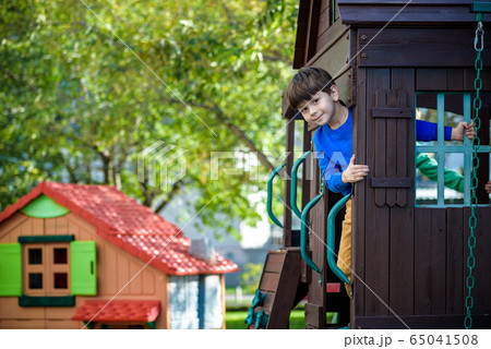 Little boy climbing ladder on slide at playground. 65041508