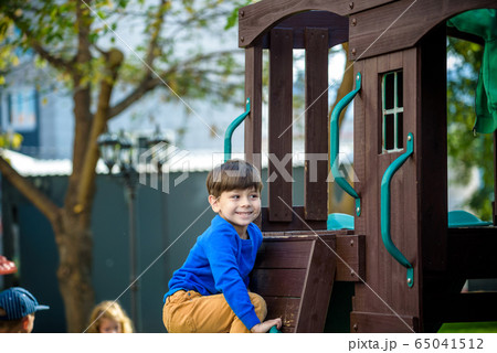 Little boy climbing ladder on slide at playground. Little boy climbing ladder on slide at playground. 65041512