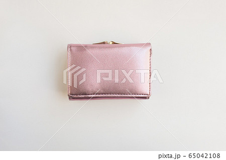 metalized pink pastel female wallet on a white background flat layout view reconciliation. Business, finance, money 65042108