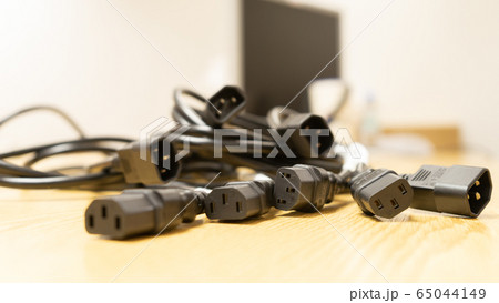 Black power cable of server on wooden table. Black power cable of server on wooden table. 65044149