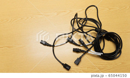 Black power cable of server on wooden table. 65044150