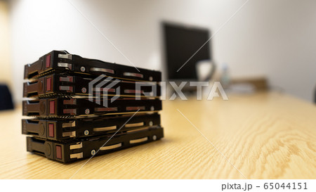 Side of server harddisk old on brown wooden table. Side of server harddisk old on brown wooden table. 65044151
