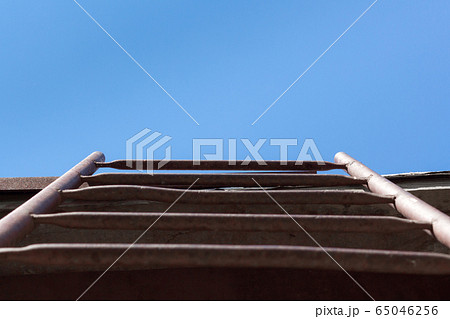 Red Staircase Rests Against Blue Sky. Development motivation Career Growth Concept Red Staircase Rests Against Blue Sky. Development motivation Career Growth Concept 65046256