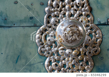 Decorative metallic handle on ironwork doors fittings, vintage light blue gate, azure color Decorative metallic handle on ironwork doors fittings, vintage light blue gate, azure color 65046299