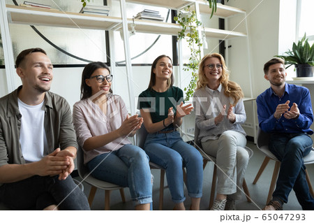 Diverse happy team applauding sitting at conference clapping hands. 65047293