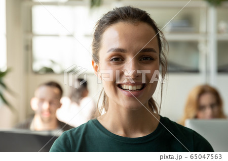 Close up headshot portrait picture of happy attractive young businesswoman. 65047563