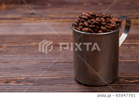 Steel mug overfilled with cup. Steel mug overfilled with cup. 65047701