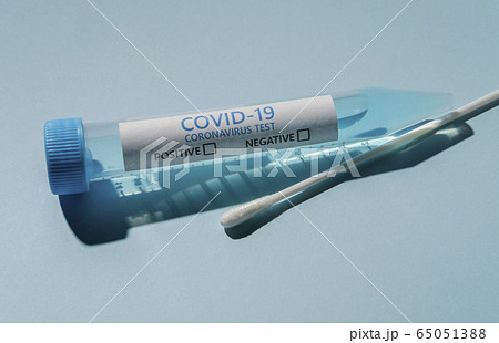 Covid-19 test vial and swab on blue background Covid-19 test vial and swab on blue background 65051388