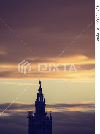 Spain, Seville, Giralda and Catherdral of Seville, Giralda tower against sunset sky 65051716