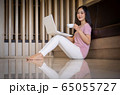 Portrait of Young asian woman sitting indoors in 65055727