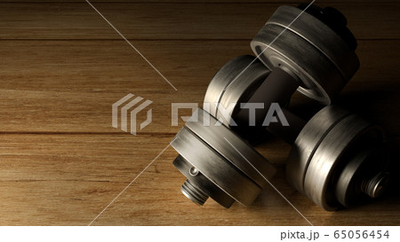 The dumbbells  wood floor dark tone 3d rendering for fitnesses content. 65056454