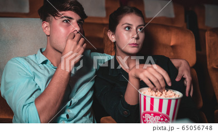 People audience watching movie in cinema theater. People audience watching movie in cinema theater. 65056748
