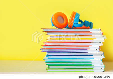 Colorful Headphones and books on color background. Concept of audiobook. 65061849
