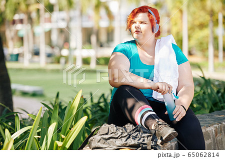 Pensive active plus size young woman 65062814