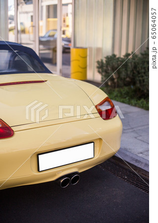 Back red lights and baggage of a yellow sport car 65064057