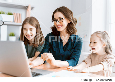 woman working on a laptop at home. woman working on a laptop at home. 65064896