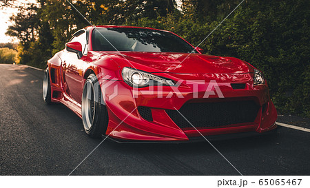 Red racing car on the highway with panoramic view in the autoshow Red racing car on the highway with panoramic view in the autoshow 65065467