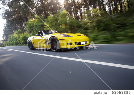Yellow supercar speed motion through forest, angle view Yellow supercar speed motion through forest, angle view 65065889