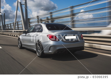 Silver business female sedan test drive over the bridge 65066395