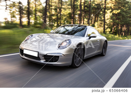 Silver sedan, forest drive in the shadow of trees Silver sedan, forest drive in the shadow of trees 65066406