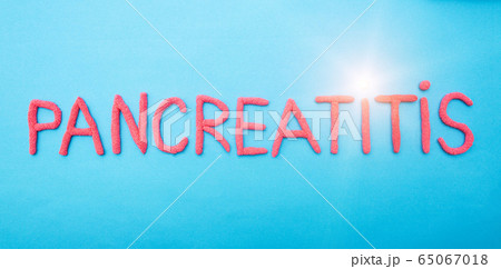 The word pancreatitis in red letters on a blue background. Pancreatic disease concept, epigastric pain and inflammation, medical 65067018