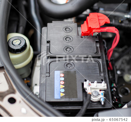 the battery in the car in the engine compartment, background, accumulator battery the battery in the car in the engine compartment, background, accumulator battery 65067542