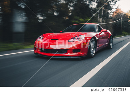 Red sport sedan on the road Red sport sedan on the road 65067553