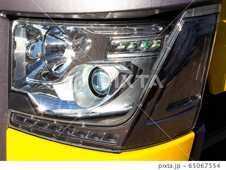 Modern truck headlight with diode illumination. Road safety concept, close-up. LED Modern truck headlight with diode illumination. Road safety concept, close-up. LED 65067554