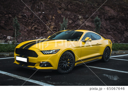 Yellow sport model car on the parking zone with black tuning Yellow sport model car on the parking zone with black tuning 65067646