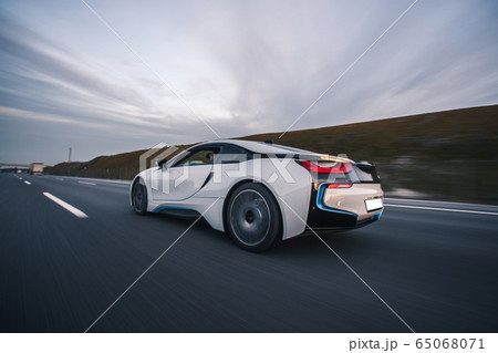 White sport car on the road, back view 65068071