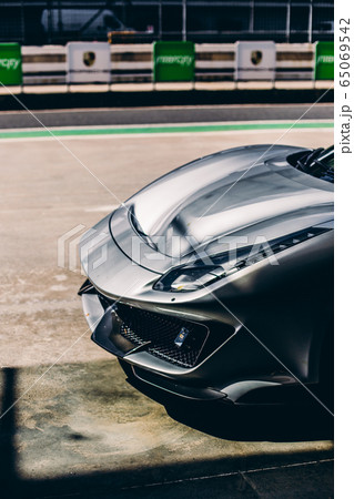 Front bumper and lights of a silver car in the stadium 65069542