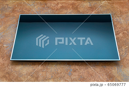 Big lcd TV on orange wall 65069777