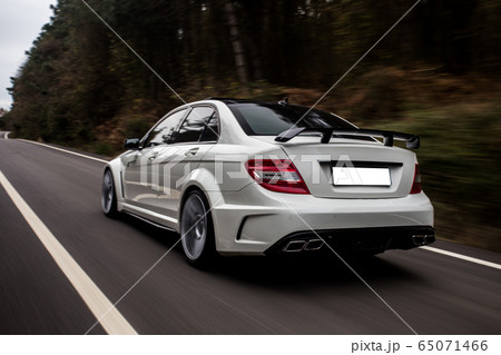 Whitesport sedan on the highway, driving in the nature 65071466