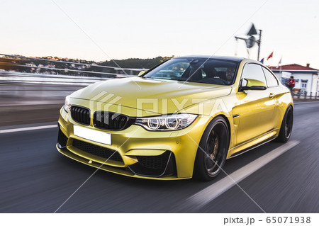 Golden sport sedan car on the autobahn. high speed drive 65071938