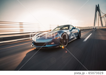 Blue brand sport car driving over the bridge Blue brand sport car driving over the bridge 65073029