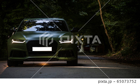 Slow motion drive of black sedan on the forest road in the darkness 65073752