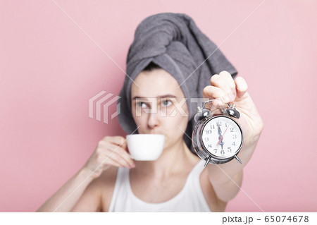 Tired and sleepy young girl drinks coffee in 65074678