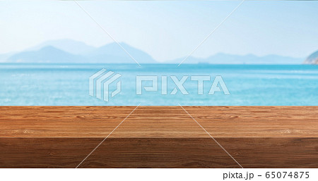 Empty plank wood table with blur blue sky and sea 65074875