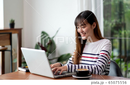 asian woman work with laptop at home see outside asian woman work with laptop at home see outside 65075556