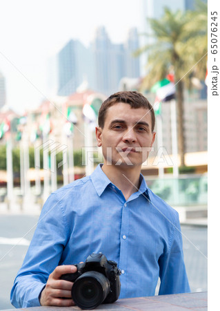 Tourist with a camera on the street of Dubai. Tourist with a camera on the street of Dubai. 65076245
