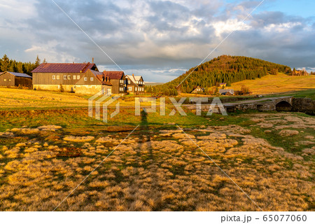 Bukovec mountain above Jizerka village at sunset time. Spring in Jizera Mountains, Czech Republic. 65077060